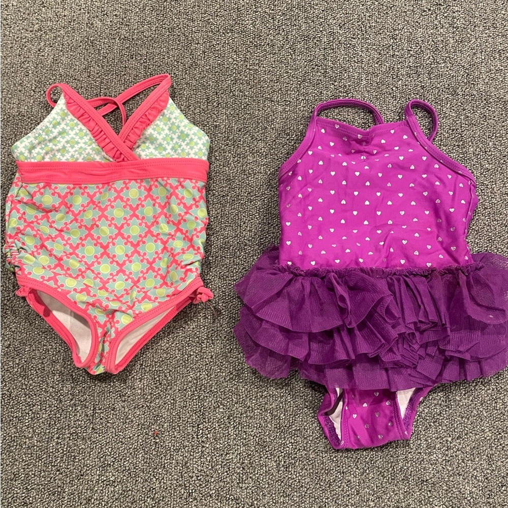 2 -One piece bathing suits 12-18 months. 1 purple & 1 pink/green. Good condition